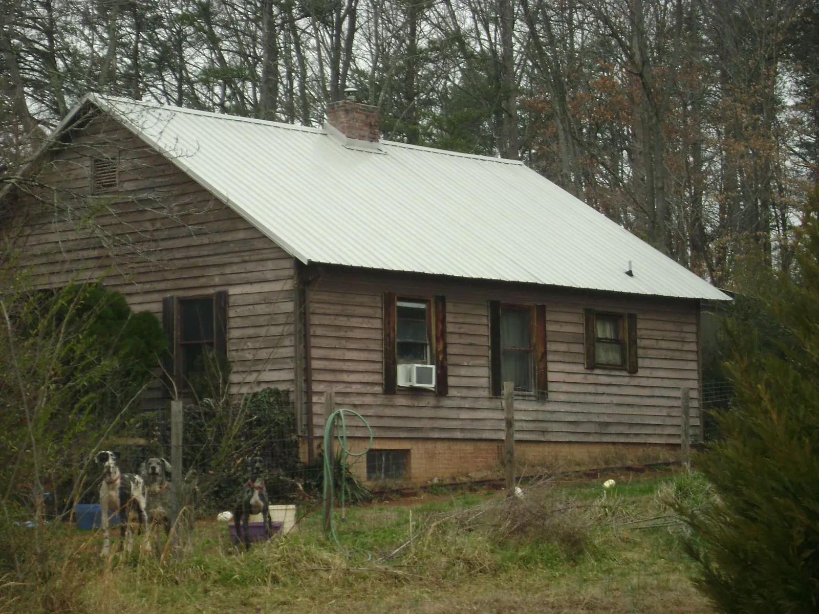 White metal roof on an old wood sided farmhouse, from a Metal Roof Installation job in Leesburg